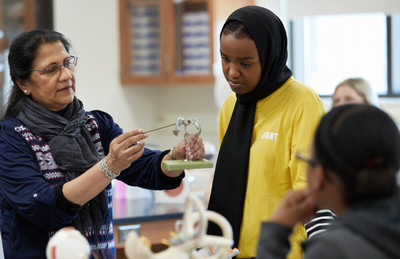 students being instructed by a professor in a classroom